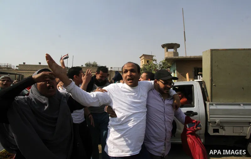 Released detainees wave to their relatives after Egyptian President Abdel Fattah al-Sisi issued a pardon for 203 youths jailed for taking part in demonstrations, as part of a pledge he made months ago to amend a protest...