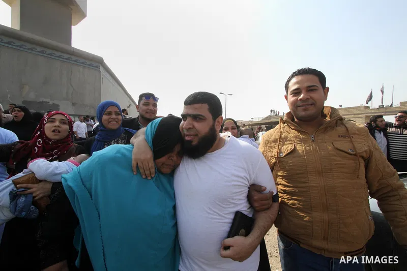 Released detainees wave to their relatives after Egyptian President Abdel Fattah al-Sisi issued a pardon for 203 youths jailed for taking part in demonstrations, as part of a pledge he made months ago to amend a protest...