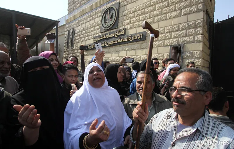 Released detainees wave to their relatives after Egyptian President Abdel Fattah al-Sisi issued a pardon for 203 youths jailed for taking part in demonstrations, as part of a pledge he made months ago to amend a protest...
