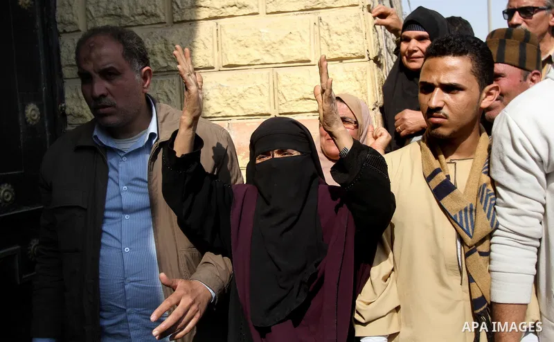 Released detainees wave to their relatives after Egyptian President Abdel Fattah al-Sisi issued a pardon for 203 youths jailed for taking part in demonstrations, as part of a pledge he made months ago to amend a protest...