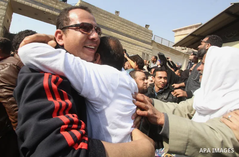 Released detainees wave to their relatives after Egyptian President Abdel Fattah al-Sisi issued a pardon for 203 youths jailed for taking part in demonstrations, as part of a pledge he made months ago to amend a protest...