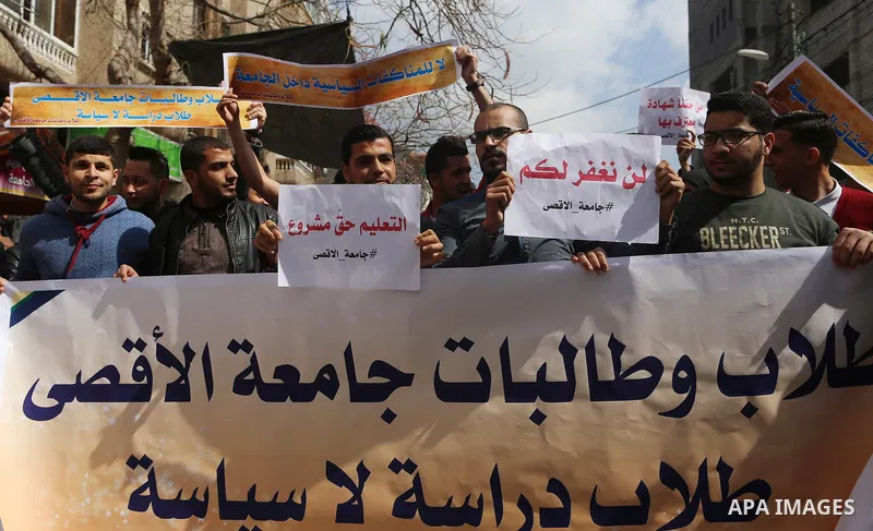 Palestinian students from the Al-Aqsa University, take part in a protest to demand their rights, in Gaza city, on March 15, 2017. Photo by Ashraf Amra