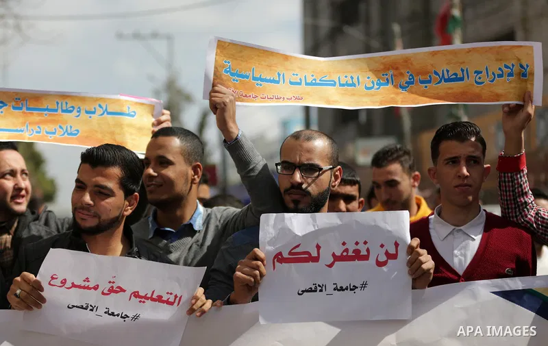 Palestinian students from the Al-Aqsa University, take part in a protest to demand their rights, in Gaza city, on March 15, 2017. Photo by Ashraf Amra