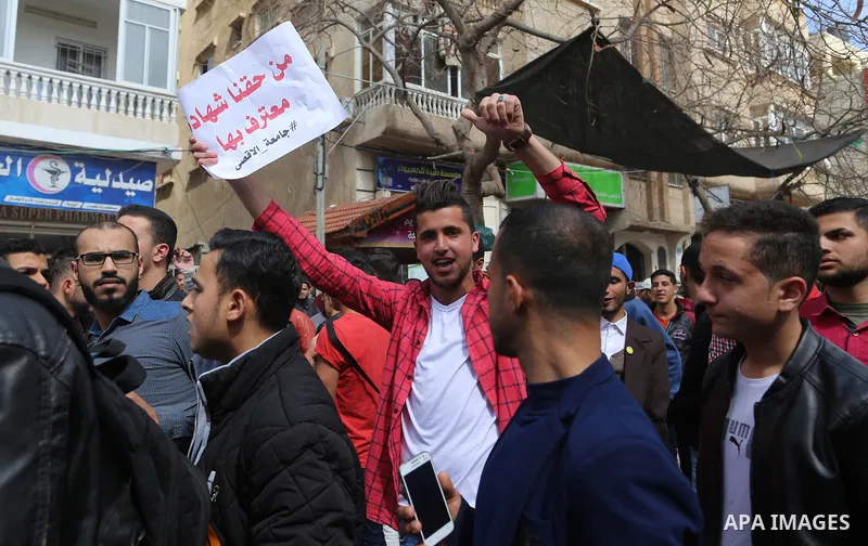 Palestinian students from the Al-Aqsa University, take part in a protest to demand their rights, in Gaza city, on March 15, 2017. Photo by Ashraf Amra