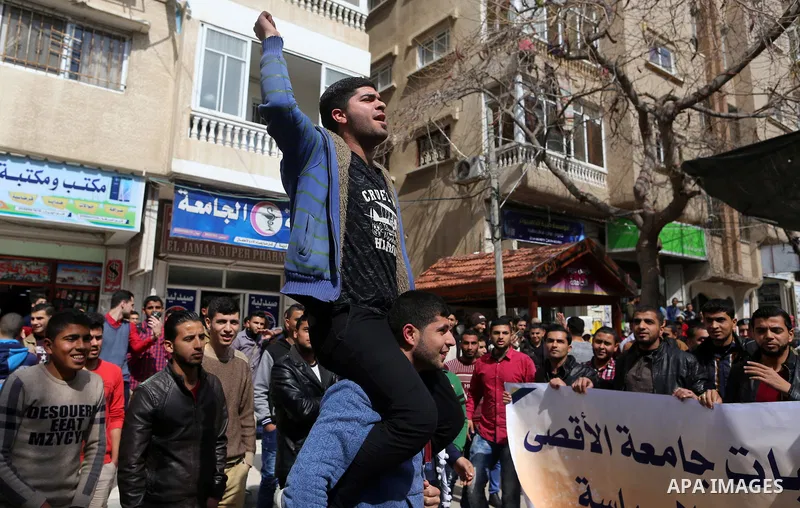 Palestinian students from the Al-Aqsa University, take part in a protest to demand their rights, in Gaza city, on March 15, 2017. Photo by Ashraf Amra