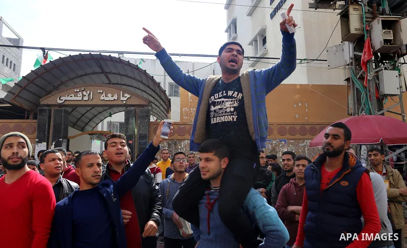 Palestinian students from the Al-Aqsa University, take part in a protest to demand their rights, in Gaza city, on March 15, 2017. Photo by Ashraf Amra