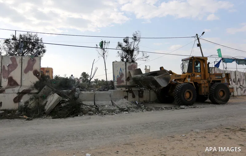 A Palestinian bulldozer demolishes a Hamas site, which according to the Gaza police, was hit by an Israeli air strike, in Deir El-Balah, in the central Gaza Strip March 16, 2017. Photo by Ashraf Amra
