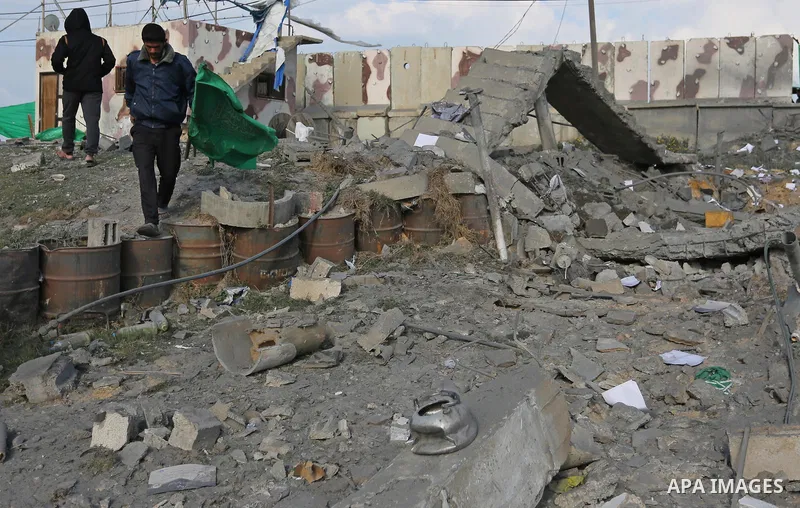 Palestinians look at a Hamas site, which according to the Gaza police, was hit by an Israeli air strike, in Deir El-Balah, in the central Gaza Strip March 16, 2017. Photo by Ashraf Amra