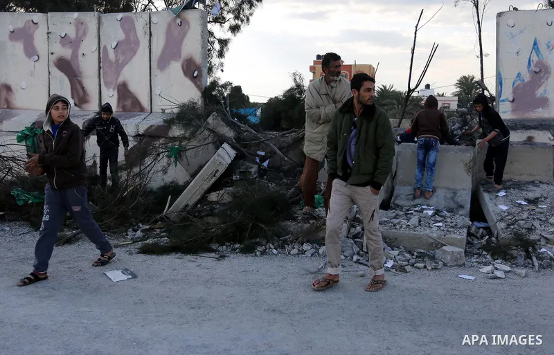 Palestinians look at a Hamas site, which according to the Gaza police, was hit by an Israeli air strike, in Deir El-Balah, in the central Gaza Strip March 16, 2017. Photo by Ashraf Amra