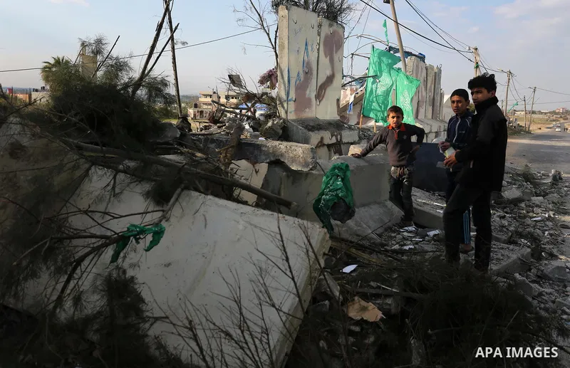Palestinians look at a Hamas site, which according to the Gaza police, was hit by an Israeli air strike, in Deir El-Balah, in the central Gaza Strip March 16, 2017. Photo by Ashraf Amra
