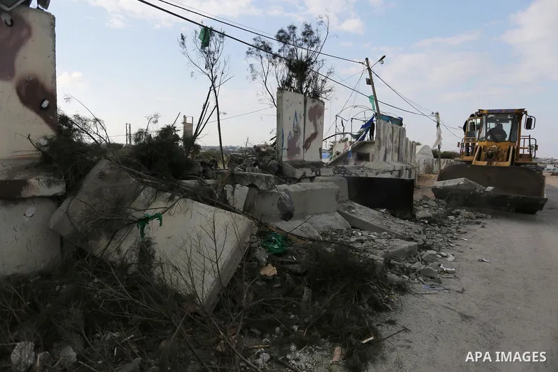 A Palestinian bulldozer demolishes a Hamas site, which according to the Gaza police, was hit by an Israeli air strike, in Deir El-Balah, in the central Gaza Strip March 16, 2017. Photo by Ashraf Amra