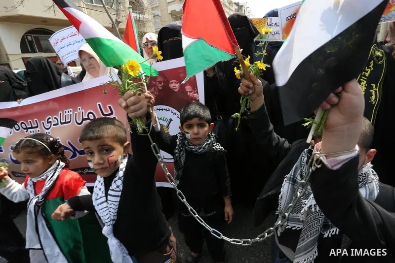 Palestinian children take part in a solidarity demonstration for Palestinian female prisoners in Israeli jails in front of International Red Cross office in Gaza City, Gaza on March 16, 2017. Photo by Ashraf Amra