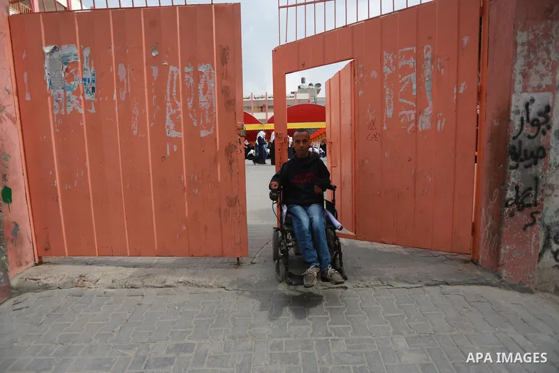 Disabled Palestinian, Mohammed abu Kmail, visits the schools, in Gaza city, on March 16, 2017, during an Initiative of the Disabled Union to introduce the disabled and how society deals with people with special needs. Ph...