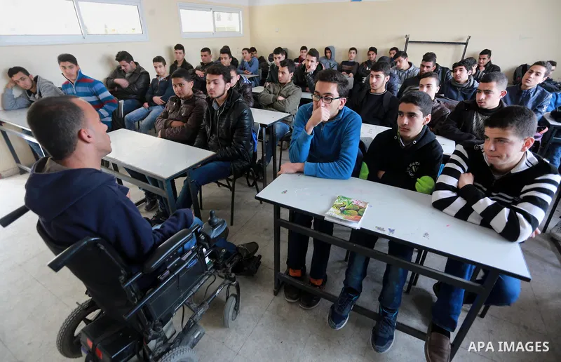 Disabled Palestinian, Mohammed abu Kmail, visits the schools, in Gaza city, on March 16, 2017, during an Initiative of the Disabled Union to introduce the disabled and how society deals with people with special needs. Ph...