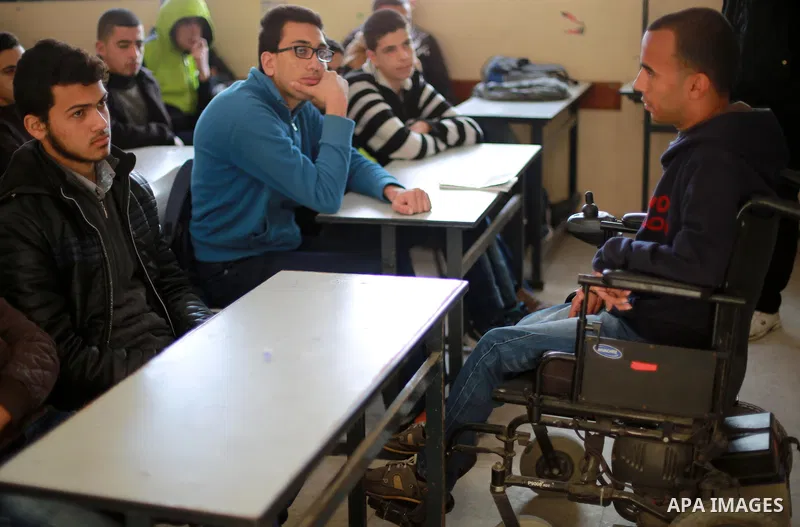 Disabled Palestinian, Mohammed abu Kmail, visits the schools, in Gaza city, on March 16, 2017, during an Initiative of the Disabled Union to introduce the disabled and how society deals with people with special needs. Ph...