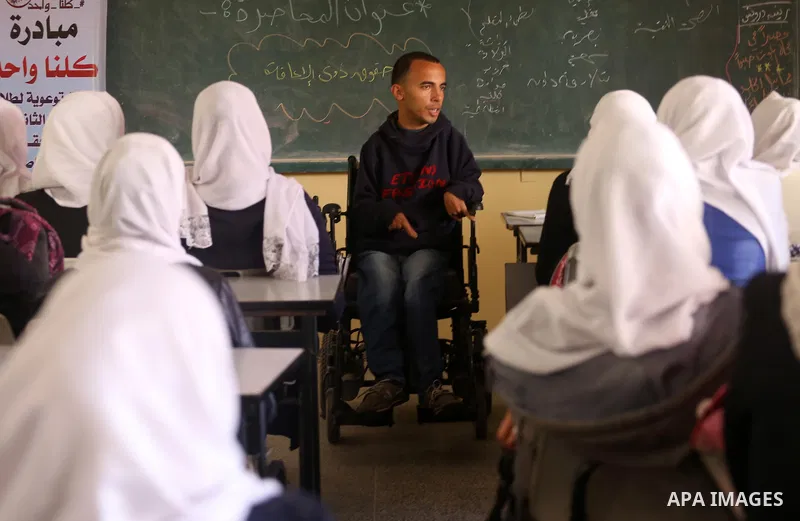Disabled Palestinian, Mohammed abu Kmail, visits the schools, in Gaza city, on March 16, 2017, during an Initiative of the Disabled Union to introduce the disabled and how society deals with people with special needs. Ph...