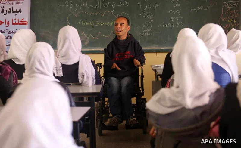 Disabled Palestinian, Mohammed abu Kmail, visits the schools, in Gaza city, on March 16, 2017, during an Initiative of the Disabled Union to introduce the disabled and how society deals with people with special needs. Ph...