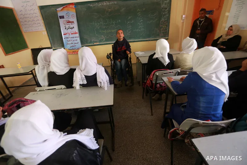 Disabled Palestinian, Mohammed abu Kmail, visits the schools, in Gaza city, on March 16, 2017, during an Initiative of the Disabled Union to introduce the disabled and how society deals with people with special needs. Ph...