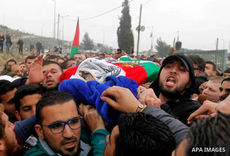 Palestinians carry the body of Basel al-Araj, who was killed by Israeli forces during a clash, during his funeral in the West Bank village of Walaja near Bethlehem, March 17, 2017. Photo by Wisam Hashlamoun