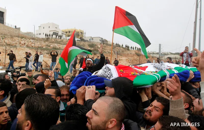 Palestinians carry the body of Basel al-Araj, who was killed by Israeli forces during a clash, during his funeral in the West Bank village of Walaja near Bethlehem, March 17, 2017. Photo by Wisam Hashlamoun