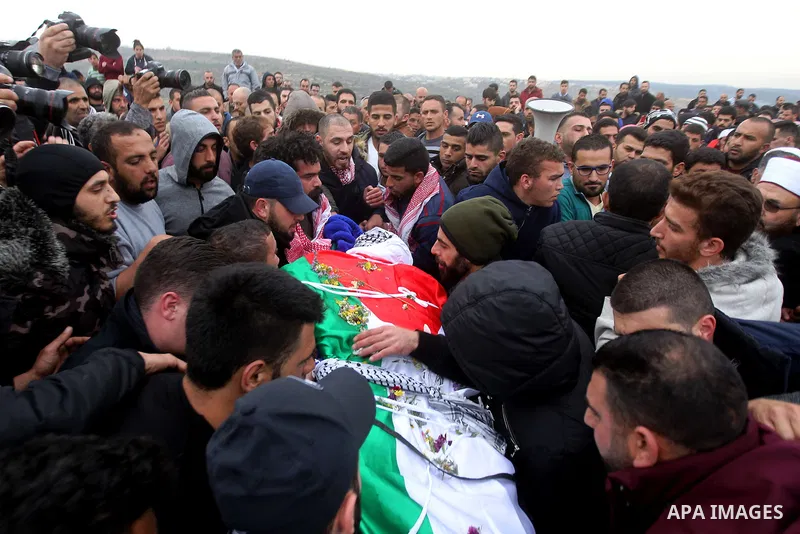 Palestinians carry the body of Basel al-Araj, who was killed by Israeli forces during a clash, during his funeral in the West Bank village of Walaja near Bethlehem, March 17, 2017. Photo by Wisam Hashlamoun