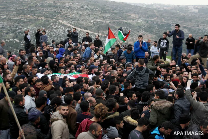 Palestinians carry the body of Basel al-Araj, who was killed by Israeli forces during a clash, during his funeral in the West Bank village of Walaja near Bethlehem, March 17, 2017. Photo by Wisam Hashlamoun