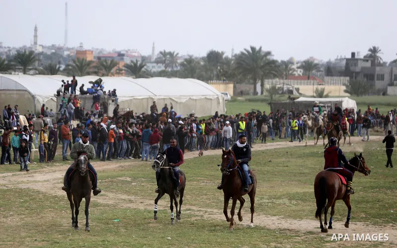 Palestinians ride horses during a heritage festival in Zawayda in the central Gaza Strip March 17, 2017. Photo by Ashraf Amra