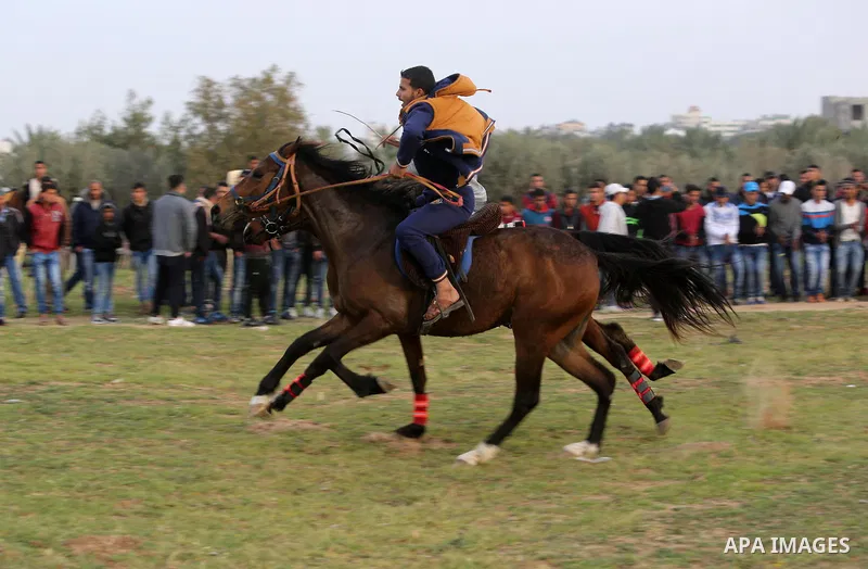 Palestinians ride horses during a heritage festival in Zawayda in the central Gaza Strip March 17, 2017. Photo by Ashraf Amra
