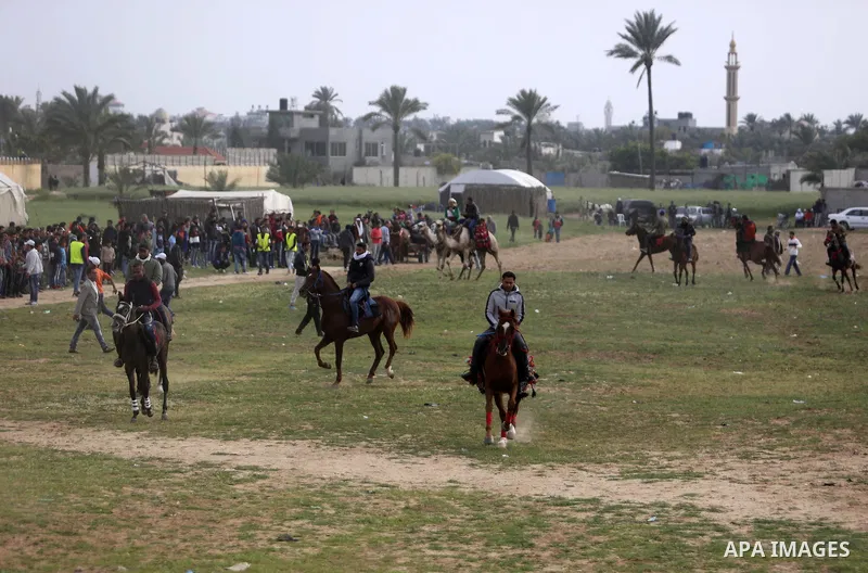 Palestinians ride horses during a heritage festival in Zawayda in the central Gaza Strip March 17, 2017. Photo by Ashraf Amra