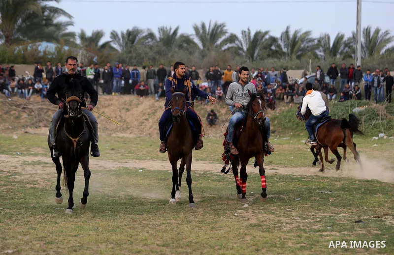 Palestinians ride horses during a heritage festival in Zawayda in the central Gaza Strip March 17, 2017. Photo by Ashraf Amra