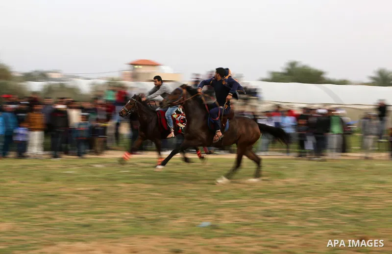 Palestinians ride horses during a heritage festival in Zawayda in the central Gaza Strip March 17, 2017. Photo by Ashraf Amra