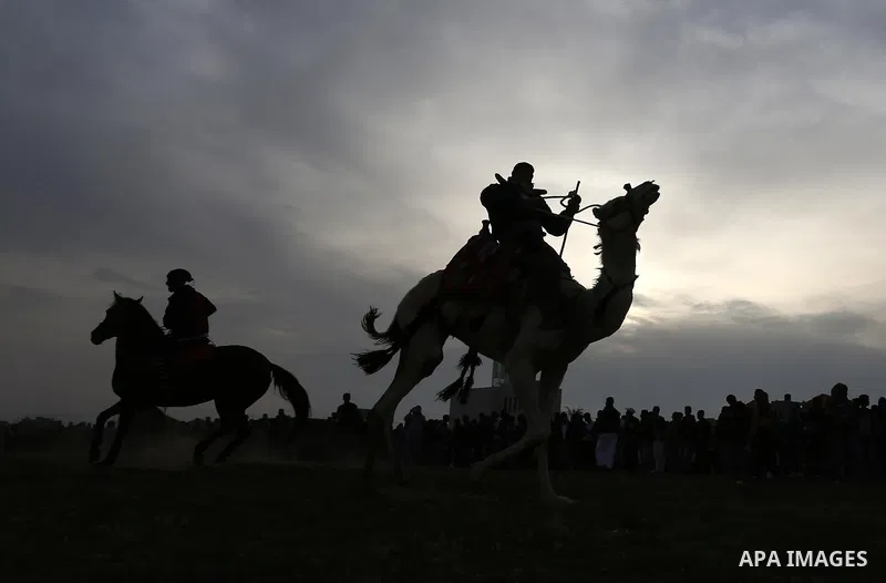 Palestinians ride horses during a heritage festival in Zawayda in the central Gaza Strip March 17, 2017. Photo by Ashraf Amra