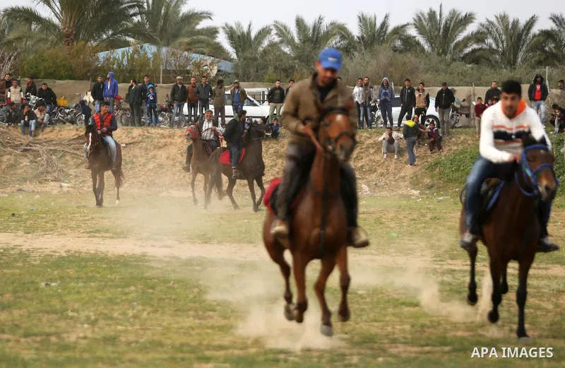 Palestinians ride horses during a heritage festival in Zawayda in the central Gaza Strip March 17, 2017. Photo by Ashraf Amra