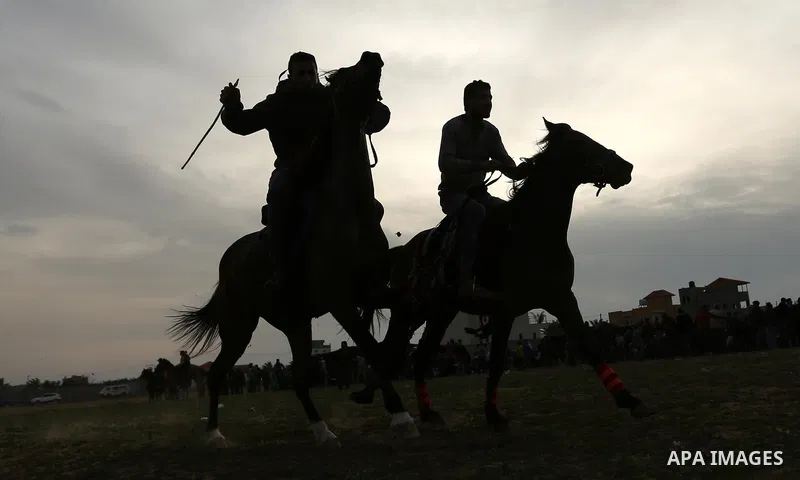 Palestinians ride horses during a heritage festival in Zawayda in the central Gaza Strip March 17, 2017. Photo by Ashraf Amra