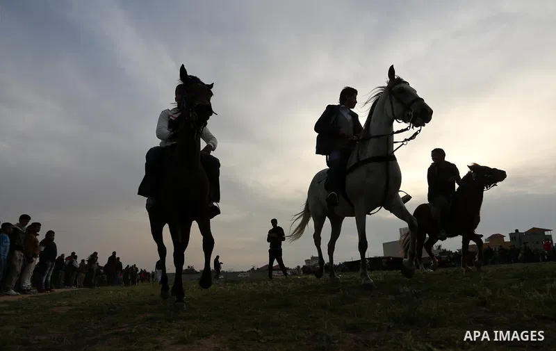 Palestinians ride horses during a heritage festival in Zawayda in the central Gaza Strip March 17, 2017. Photo by Ashraf Amra