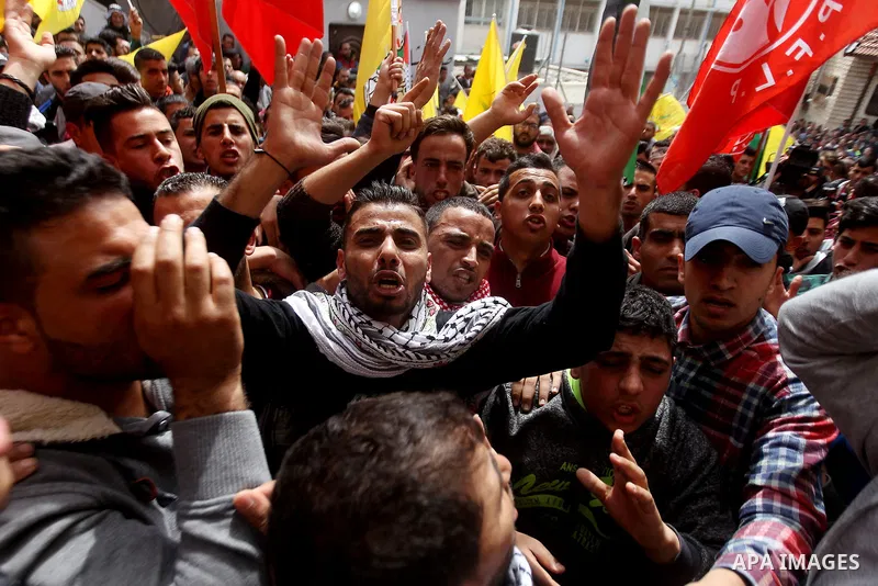 Mourners shout slogans during the funeral of Palestinian youth Morad Abu Ghazi,16, who was killed by Israeli troops during clashes, in al-Arroub refugee camp near the West Bank city of Hebron March 18, 2017. Photo by Wis...