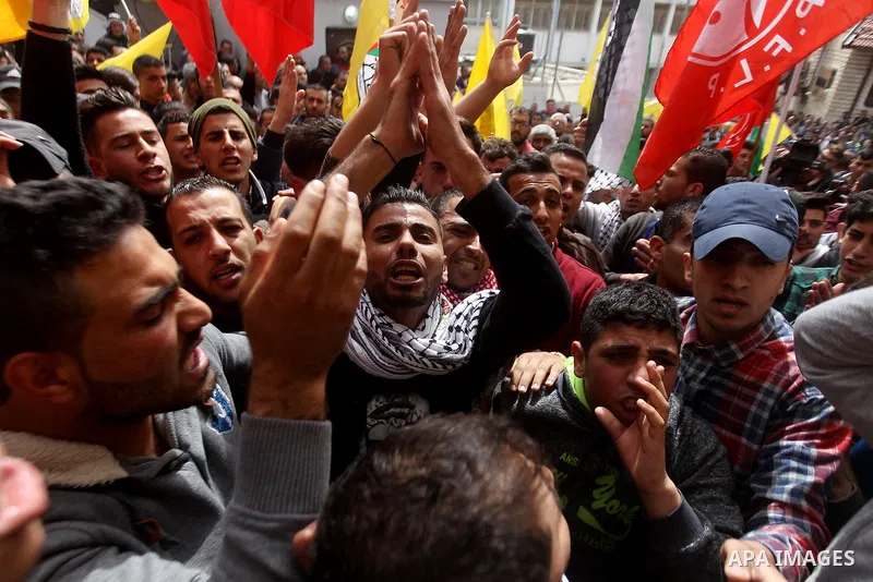 Mourners shout slogans during the funeral of Palestinian youth Morad Abu Ghazi,16, who was killed by Israeli troops during clashes, in al-Arroub refugee camp near the West Bank city of Hebron March 18, 2017. Photo by Wis...