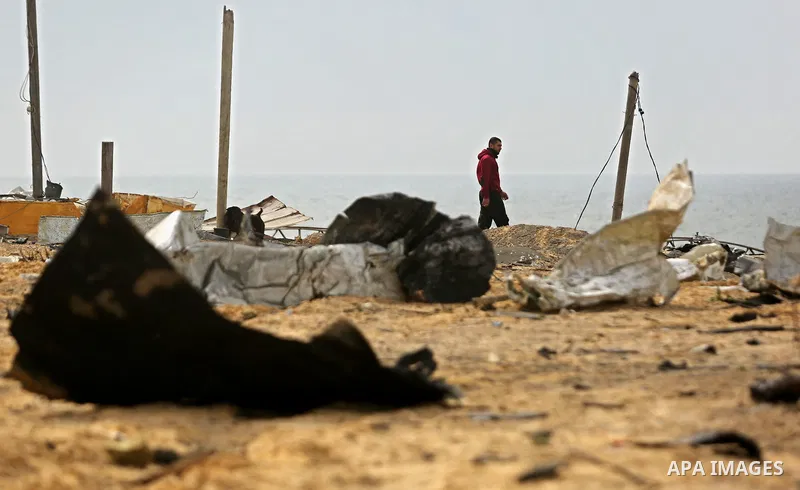 A Palestinian man walks past the scene of what Gaza police said was an Israeli air strike in Beit Lahia in the northern of Gaza Strip, on March 18, 2017. A rocket fired by Palestinians in the Gaza Strip slammed into sout...