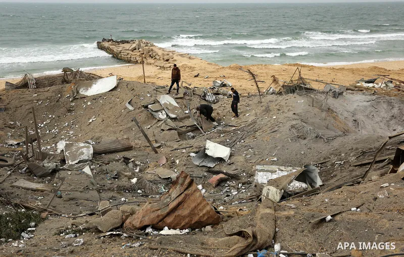 Palestinians inspect the scene of what Gaza police said was an Israeli air strike in Beit Lahia in the northern of Gaza Strip, on March 18, 2017. A rocket fired by Palestinians in the Gaza Strip slammed into southern Isr...