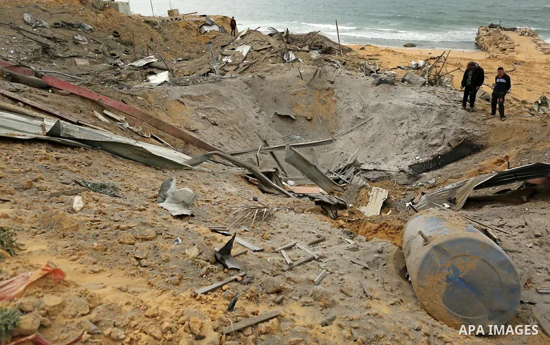 Palestinians inspect the scene of what Gaza police said was an Israeli air strike in Beit Lahia in the northern of Gaza Strip, on March 18, 2017. A rocket fired by Palestinians in the Gaza Strip slammed into southern Isr...