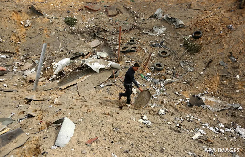 A Palestinian man inspects the scene of what Gaza police said was an Israeli air strike in Beit Lahia in the northern of Gaza Strip, on March 18, 2017. A rocket fired by Palestinians in the Gaza Strip slammed into southe...