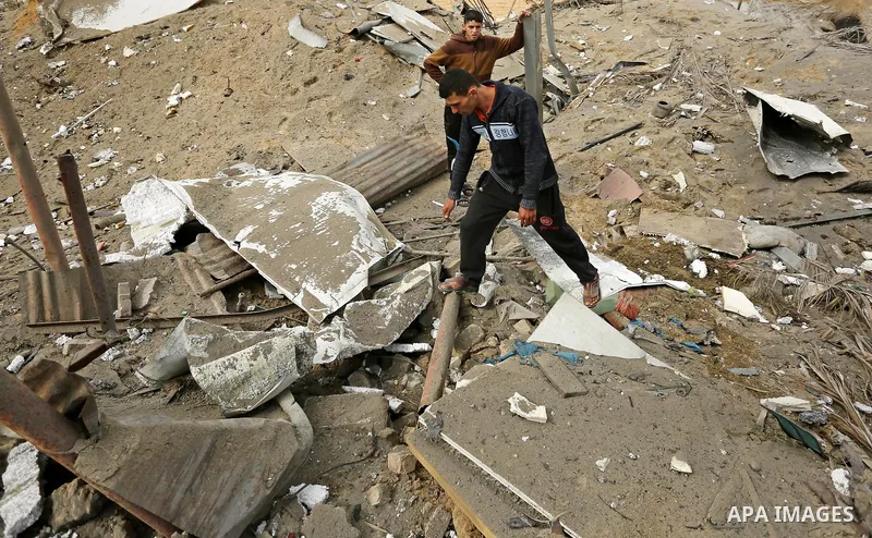 Palestinians inspect the scene of what Gaza police said was an Israeli air strike in Beit Lahia in the northern of Gaza Strip, on March 18, 2017. A rocket fired by Palestinians in the Gaza Strip slammed into southern Isr...