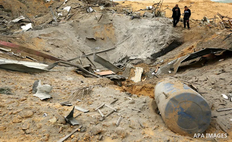 Palestinians inspect the scene of what Gaza police said was an Israeli air strike in Beit Lahia in the northern of Gaza Strip, on March 18, 2017. A rocket fired by Palestinians in the Gaza Strip slammed into southern Isr...