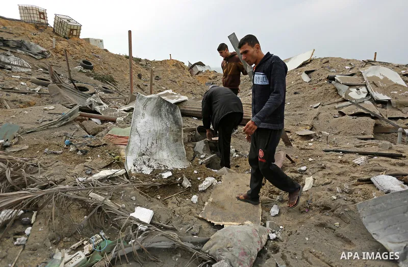 Palestinians inspect the scene of what Gaza police said was an Israeli air strike in Beit Lahia in the northern of Gaza Strip, on March 18, 2017. A rocket fired by Palestinians in the Gaza Strip slammed into southern Isr...