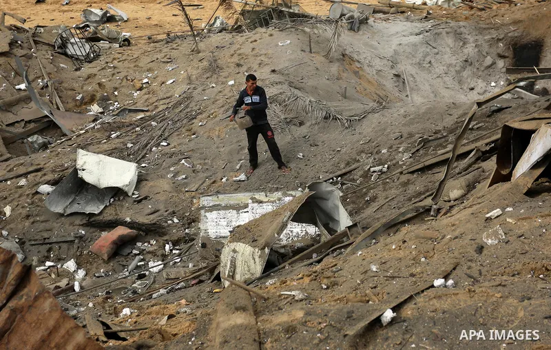 A Palestinian man inspects the scene of what Gaza police said was an Israeli air strike in Beit Lahia in the northern of Gaza Strip, on March 18, 2017. A rocket fired by Palestinians in the Gaza Strip slammed into southe...