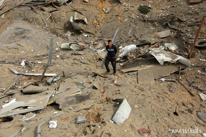 A Palestinian man inspects the scene of what Gaza police said was an Israeli air strike in Beit Lahia in the northern of Gaza Strip, on March 18, 2017. A rocket fired by Palestinians in the Gaza Strip slammed into southe...