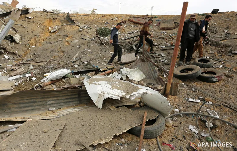 Palestinians inspect the scene of what Gaza police said was an Israeli air strike in Beit Lahia in the northern of Gaza Strip, on March 18, 2017. A rocket fired by Palestinians in the Gaza Strip slammed into southern Isr...