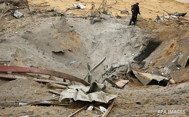 Palestinians inspect the scene of what Gaza police said was an Israeli air strike in Beit Lahia in the northern of Gaza Strip, on March 18, 2017. A rocket fired by Palestinians in the Gaza Strip slammed into southern Isr...