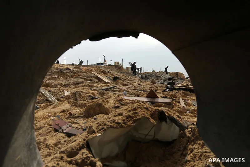 Palestinians inspect the scene of what Gaza police said was an Israeli air strike in Beit Lahia in the northern of Gaza Strip, on March 18, 2017. A rocket fired by Palestinians in the Gaza Strip slammed into southern Isr...