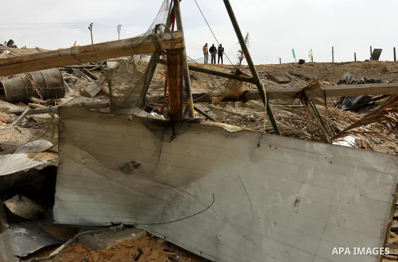 Palestinians inspect the scene of what Gaza police said was an Israeli air strike in Beit Lahia in the northern of Gaza Strip, on March 18, 2017. A rocket fired by Palestinians in the Gaza Strip slammed into southern Isr...